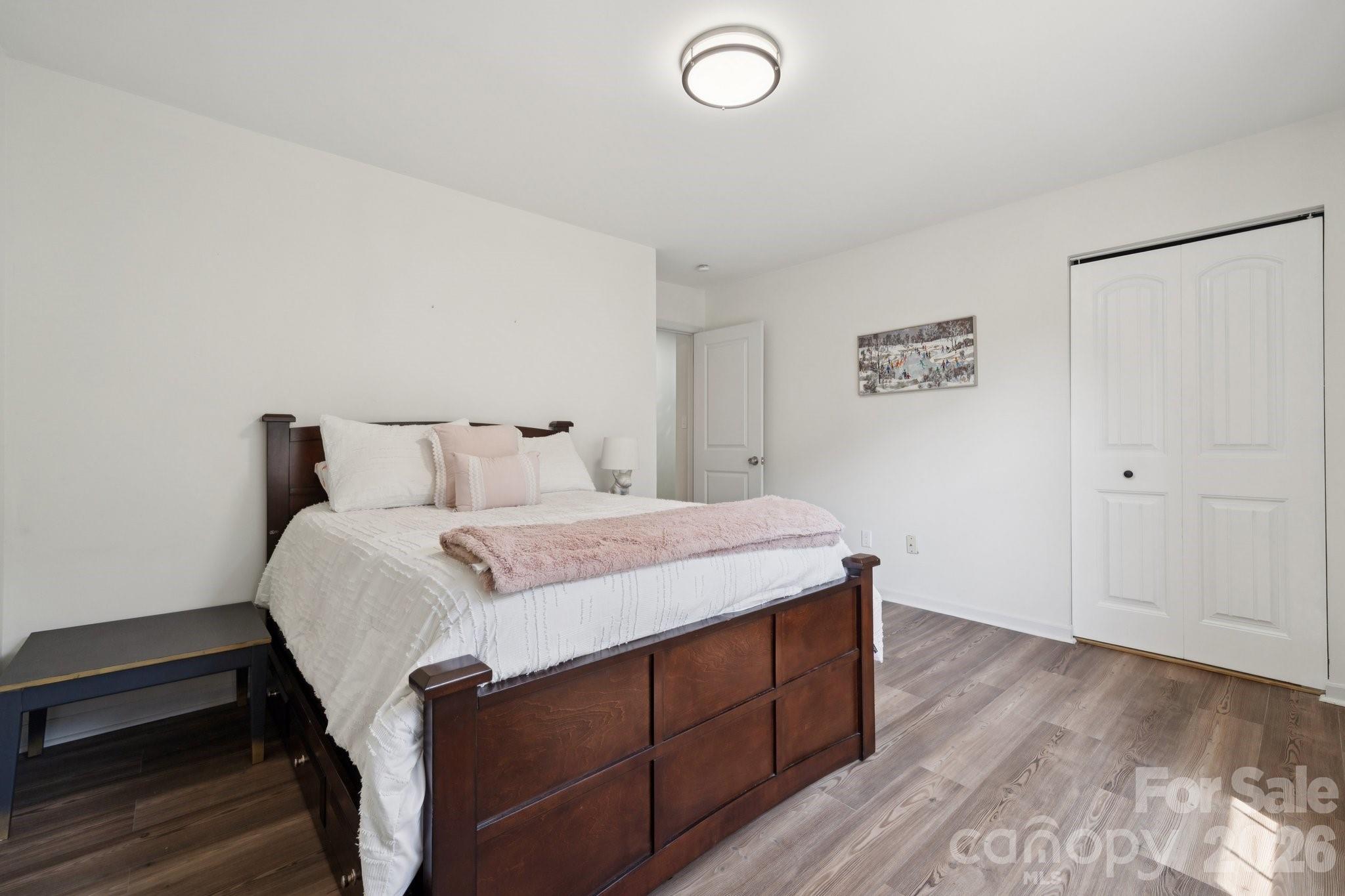 8838 Hunter Ridge Drive Charlotte, NC 28226 - Photo 22 of 27 a bedroom with a bed and cabinets