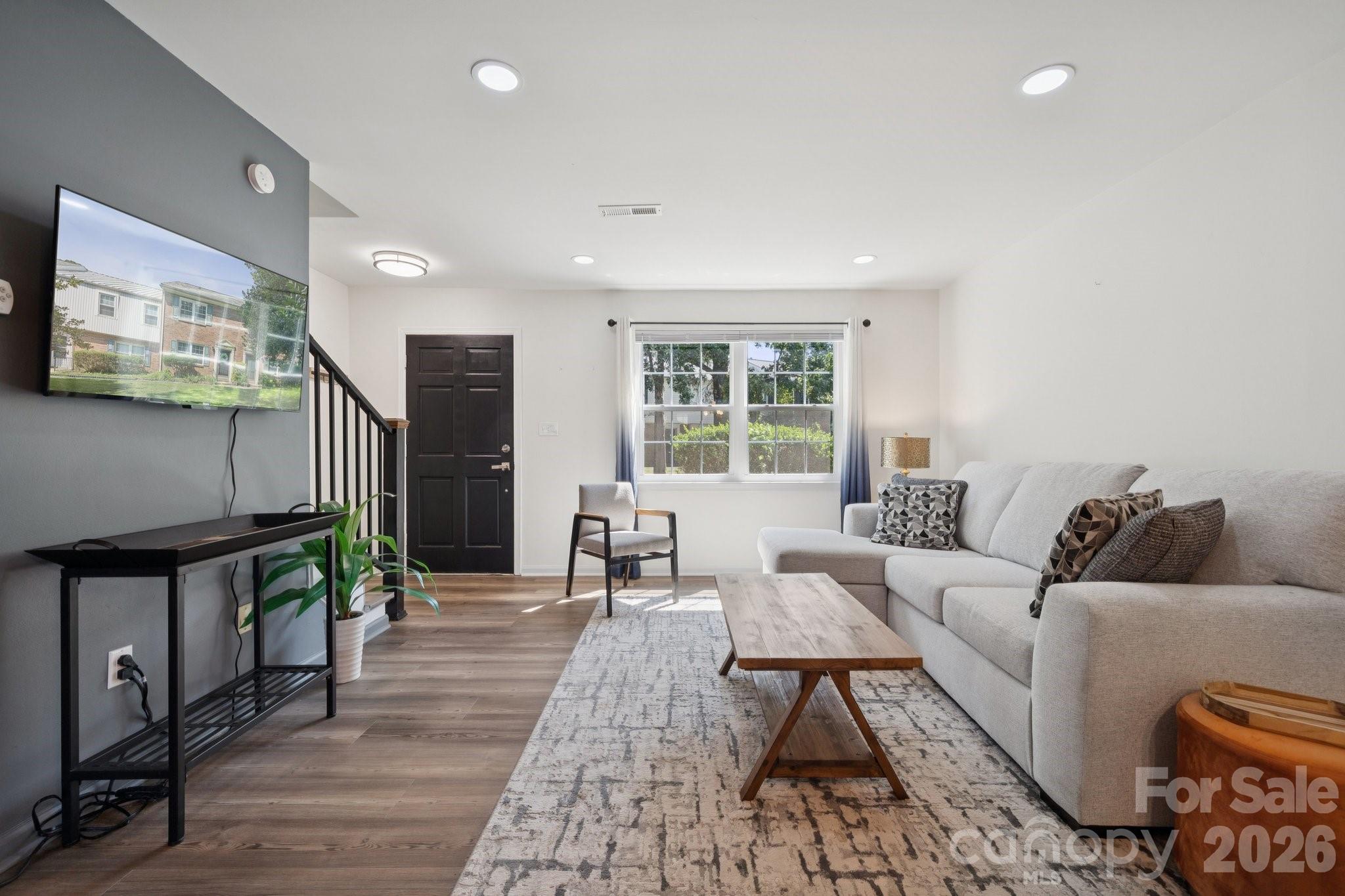 8838 Hunter Ridge Drive Charlotte, NC 28226 - Photo 3 of 27 a living room with furniture and a flat screen tv