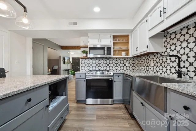a kitchen with granite countertop a stove oven and a sink