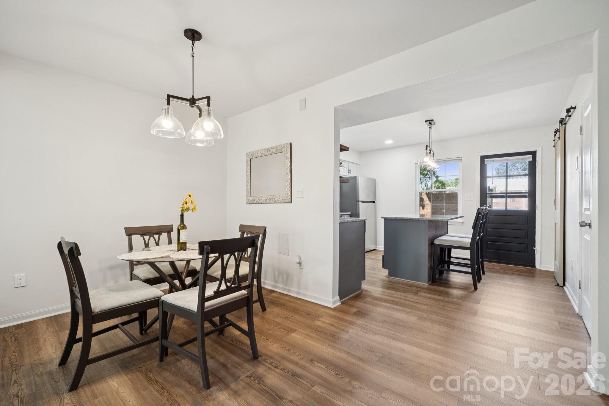 8838 Hunter Ridge Drive Charlotte, NC 28226 - Photo 6 of 27 a view of a dining room with furniture and wooden floor