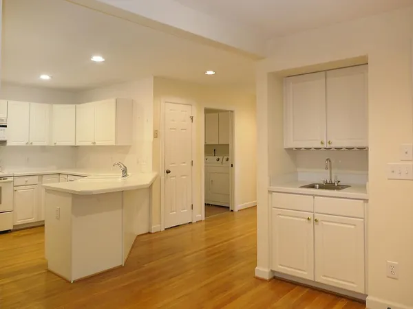 a view of a kitchen with wooden floor