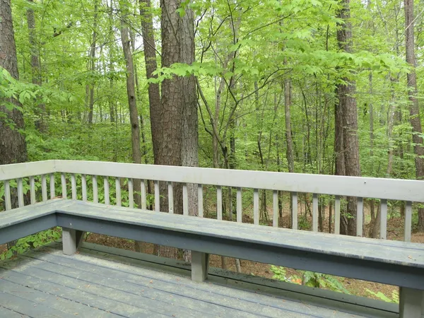 a balcony with wooden floor and outdoor space