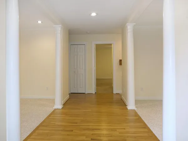 a view of hallway with wooden floor