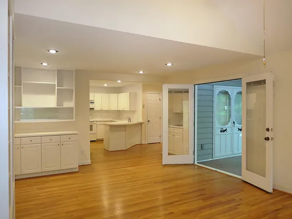 a view of a kitchen with wooden floor and a sink