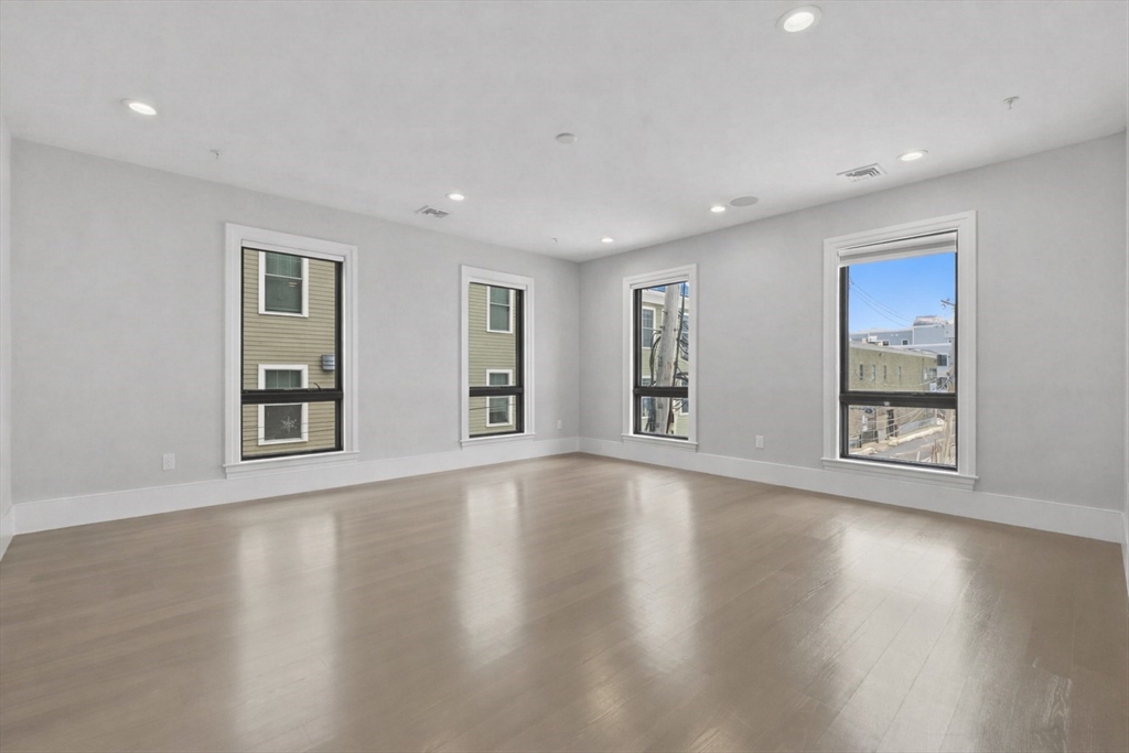 377 West First Street, Unit 5 Boston, MA 02127 - Photo 13 of 27 a view of an empty room with wooden floor and a window