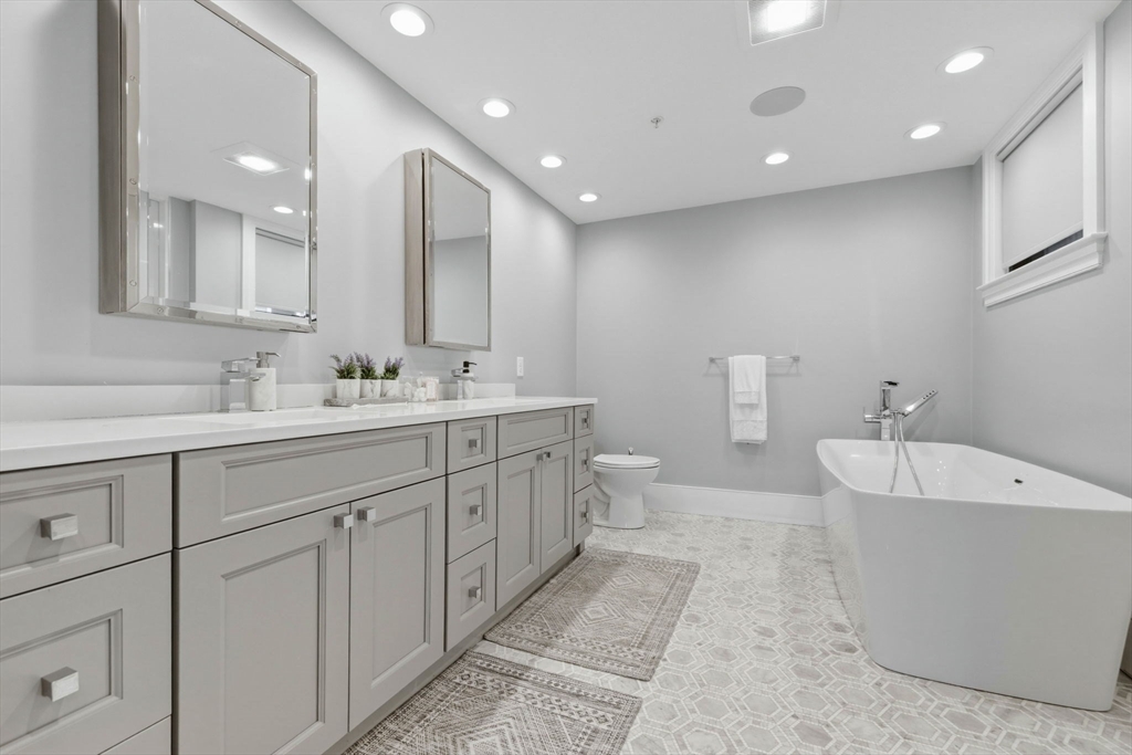377 West First Street, Unit 5 Boston, MA 02127 - Photo 16 of 27 a spacious bathroom with a double vanity sink mirror and bathtub