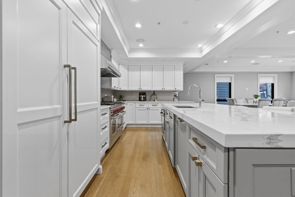 377 West First Street, Unit 5 Boston, MA 02127 - Photo 2 of 27 a kitchen with kitchen island a sink stainless steel appliances and cabinets