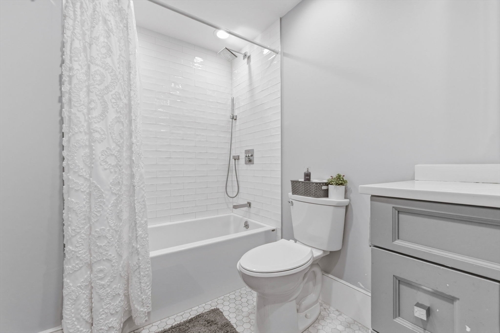 377 West First Street, Unit 5 Boston, MA 02127 - Photo 24 of 27 a bathroom with a toilet sink and bathtub