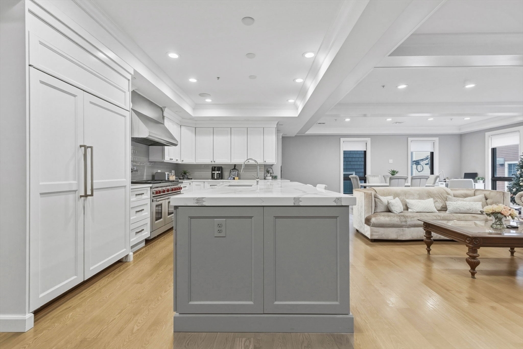 377 West First Street, Unit 5 Boston, MA 02127 - Photo 4 of 27 a kitchen with white cabinets and white appliances