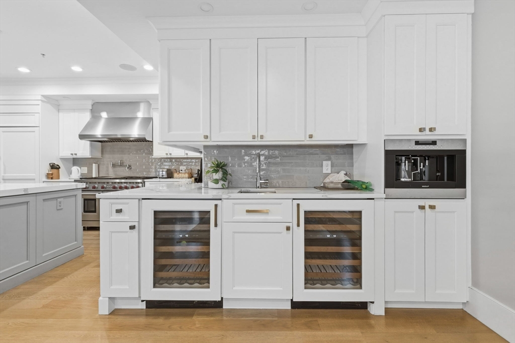 377 West First Street, Unit 5 Boston, MA 02127 - Photo 6 of 27 a kitchen with stainless steel appliances granite countertop a stove and white cabinets