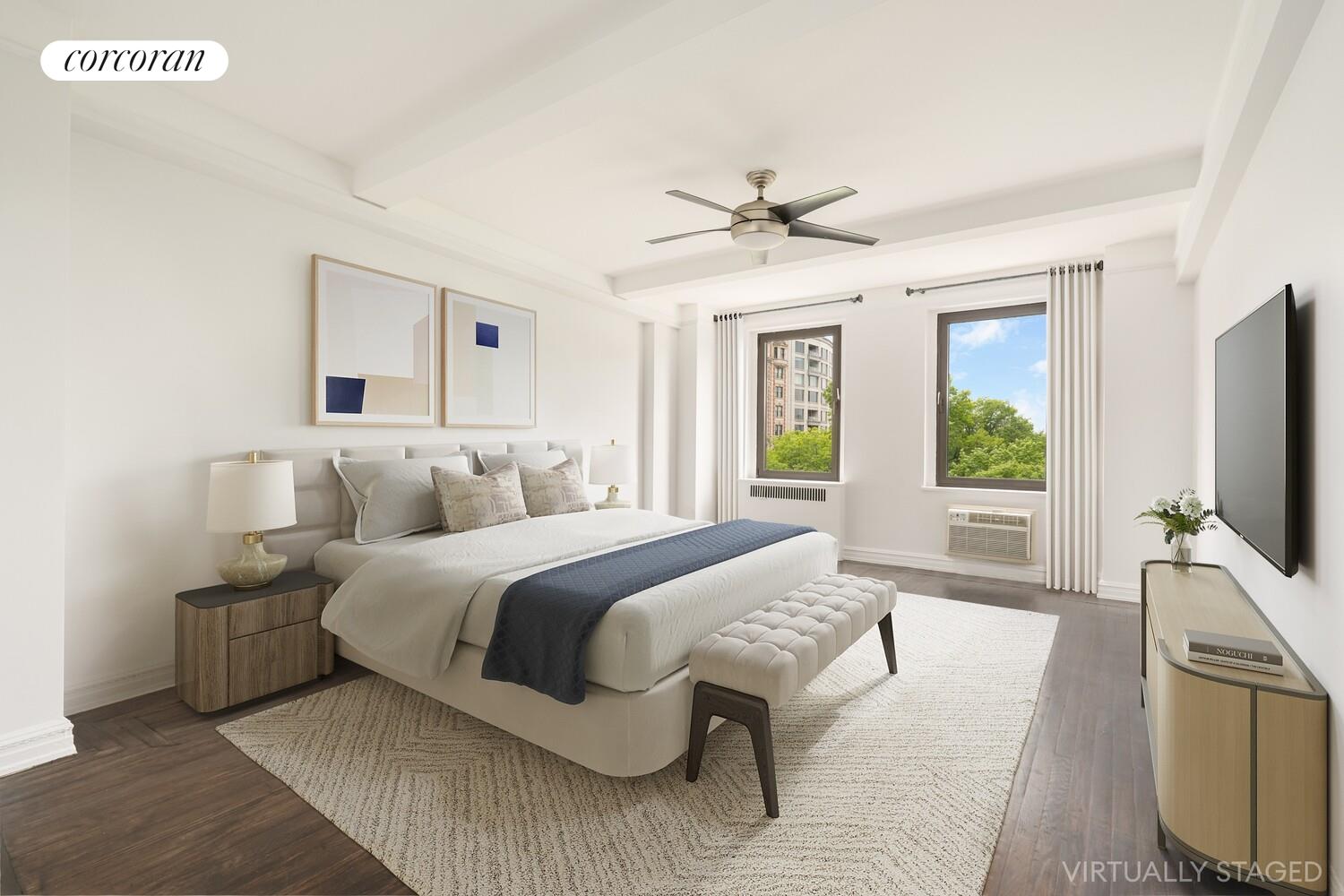 5 Riverside Drive, Unit 5A Manhattan, NY 10023 - Photo 5 of 13 a spacious bedroom with a large bed and a flat screen tv