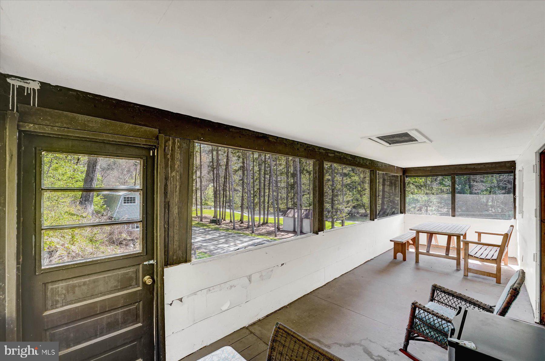 345 Spring Creek Road Bellefonte, PA 16823 - Photo 27 of 45 Serene screened porch with nature views.