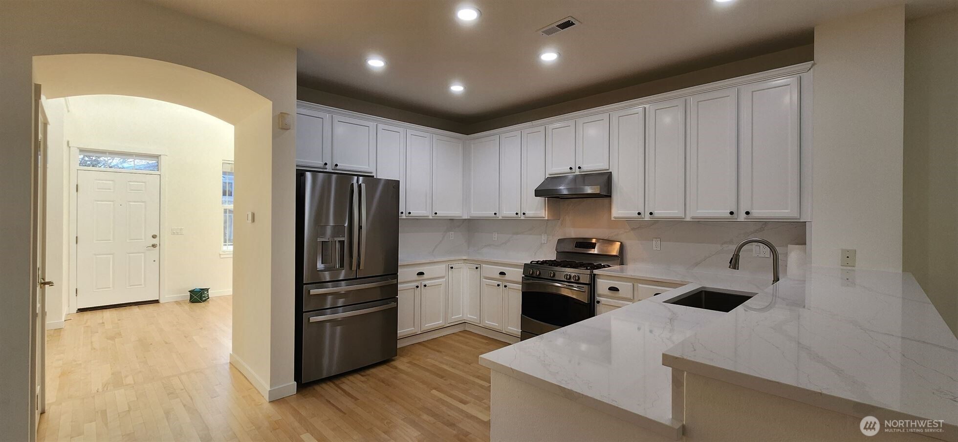 24202 Southeast 21st Street Sammamish, WA 98075 - Photo 12 of 26 a kitchen with wooden cabinets and stainless steel appliances