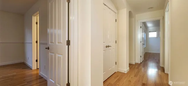 a view of a hallway with wooden floor