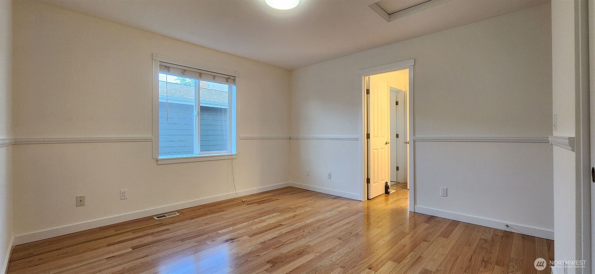 24202 Southeast 21st Street Sammamish, WA 98075 - Photo 16 of 26 an empty room with wooden floor and windows