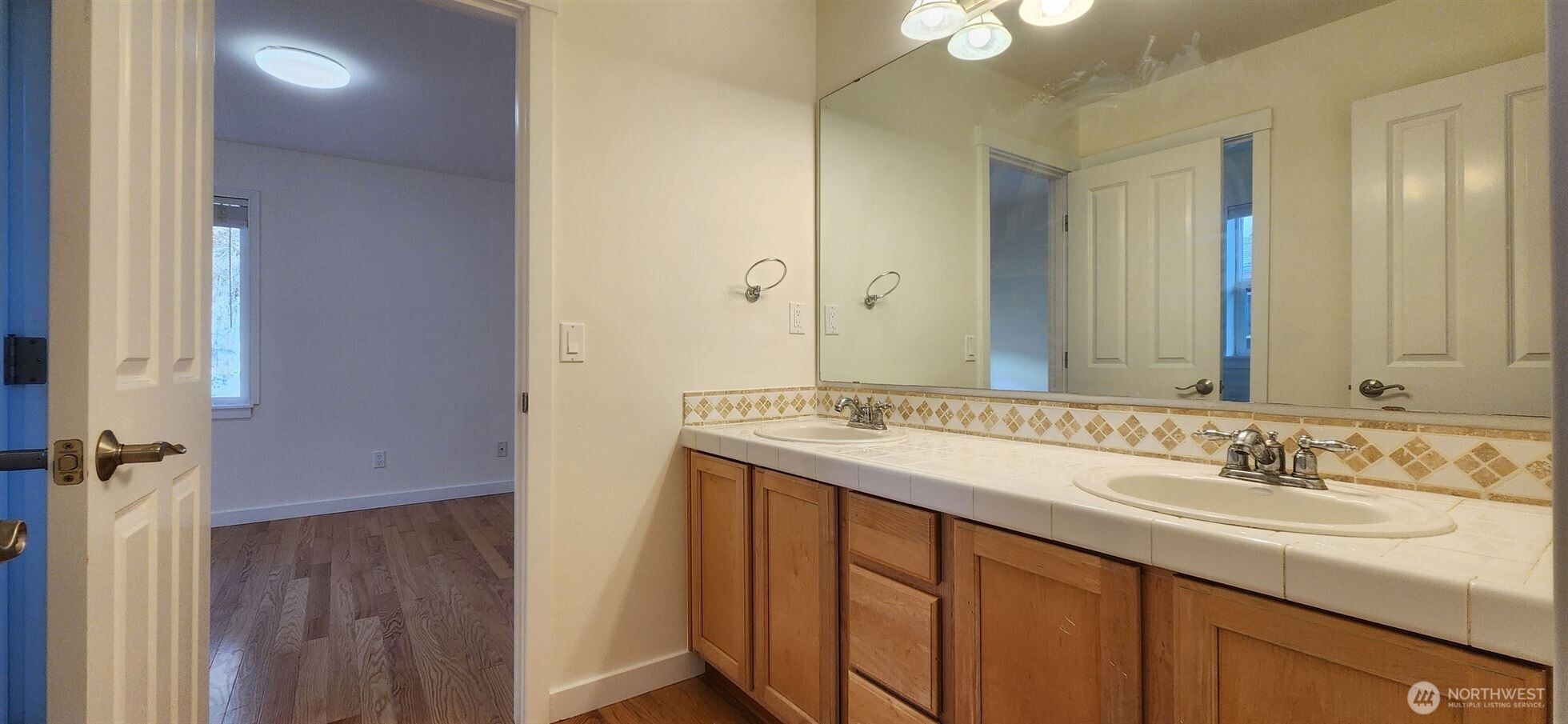24202 Southeast 21st Street Sammamish, WA 98075 - Photo 19 of 26 a bathroom with a sink and a mirror