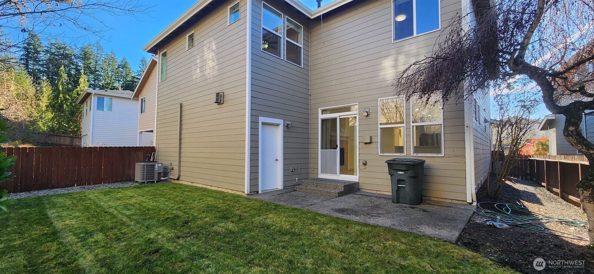 24202 Southeast 21st Street Sammamish, WA 98075 - Photo 26 of 26 a view of a white house with a small yard and a large tree