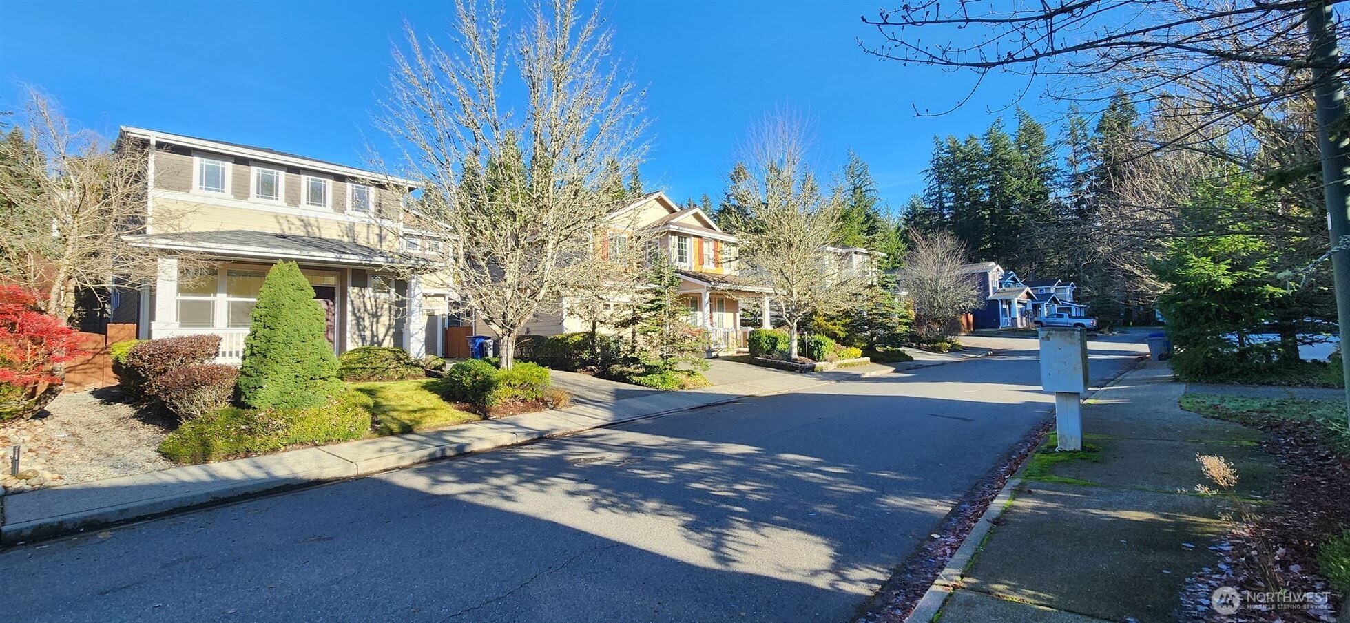 24202 Southeast 21st Street Sammamish, WA 98075 - Photo 3 of 26 a view of a street with houses on both side