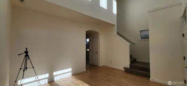 a view of a hallway with wooden floor and entryway
