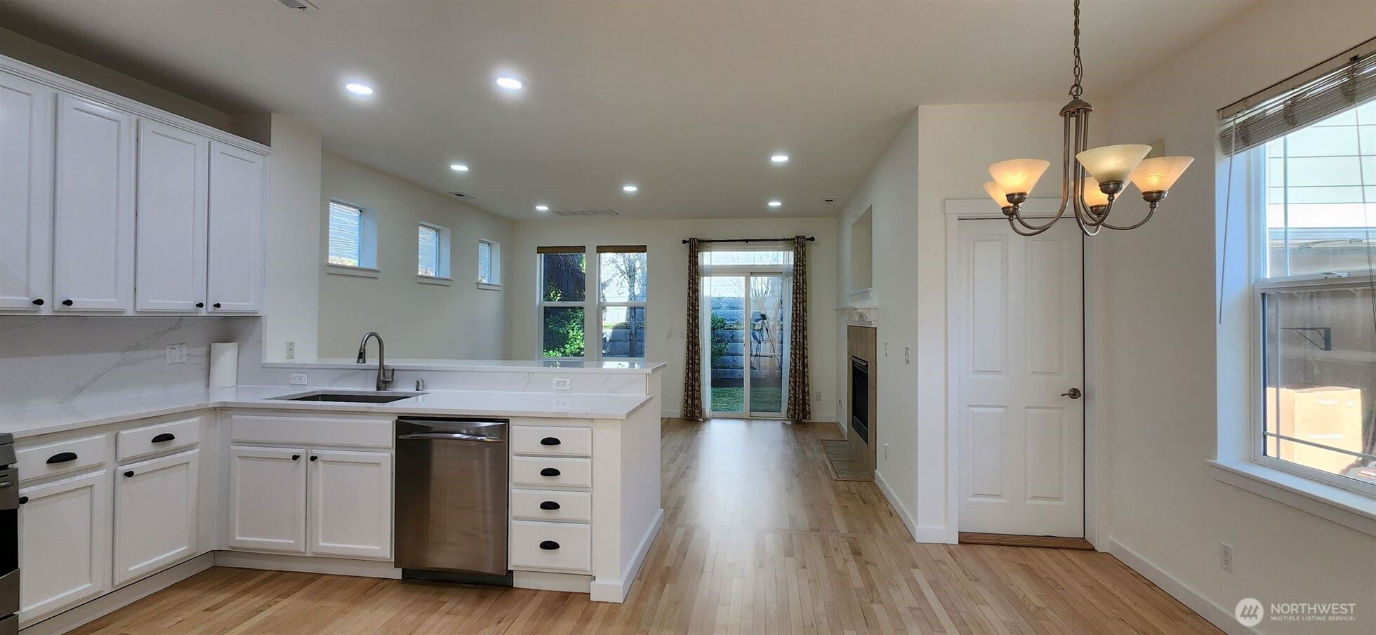 24202 Southeast 21st Street Sammamish, WA 98075 - Photo 7 of 26 a kitchen with stainless steel appliances granite countertop a sink dishwasher and a refrigerator with wooden floor