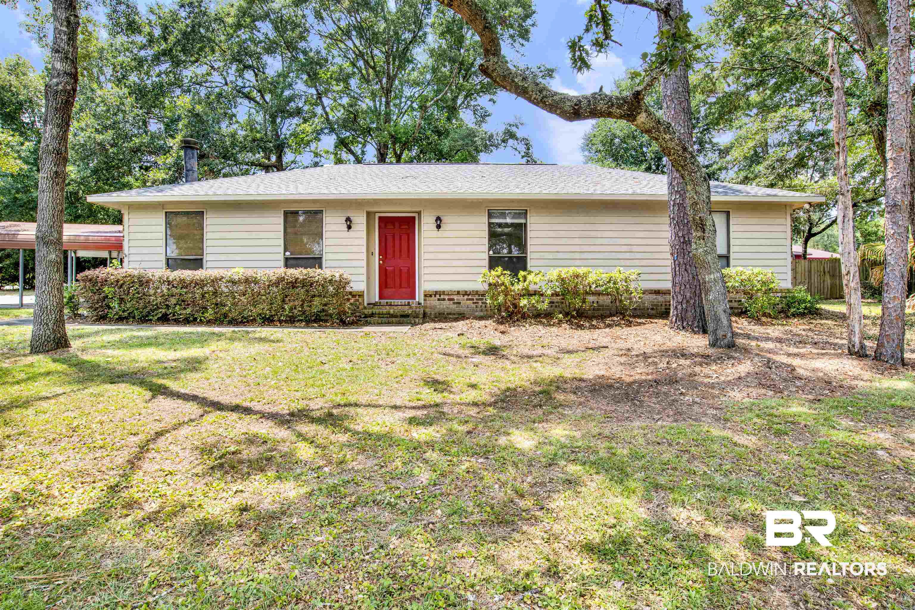 Ranch-style home featuring a front lawn
