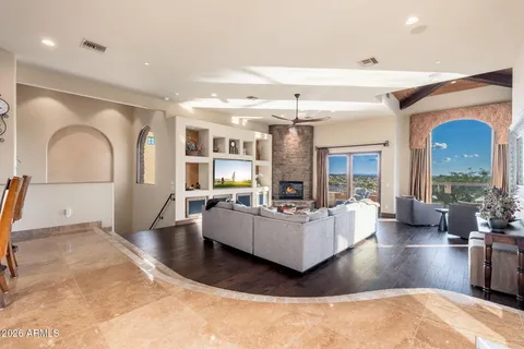 a living room with furniture and a floor to ceiling window