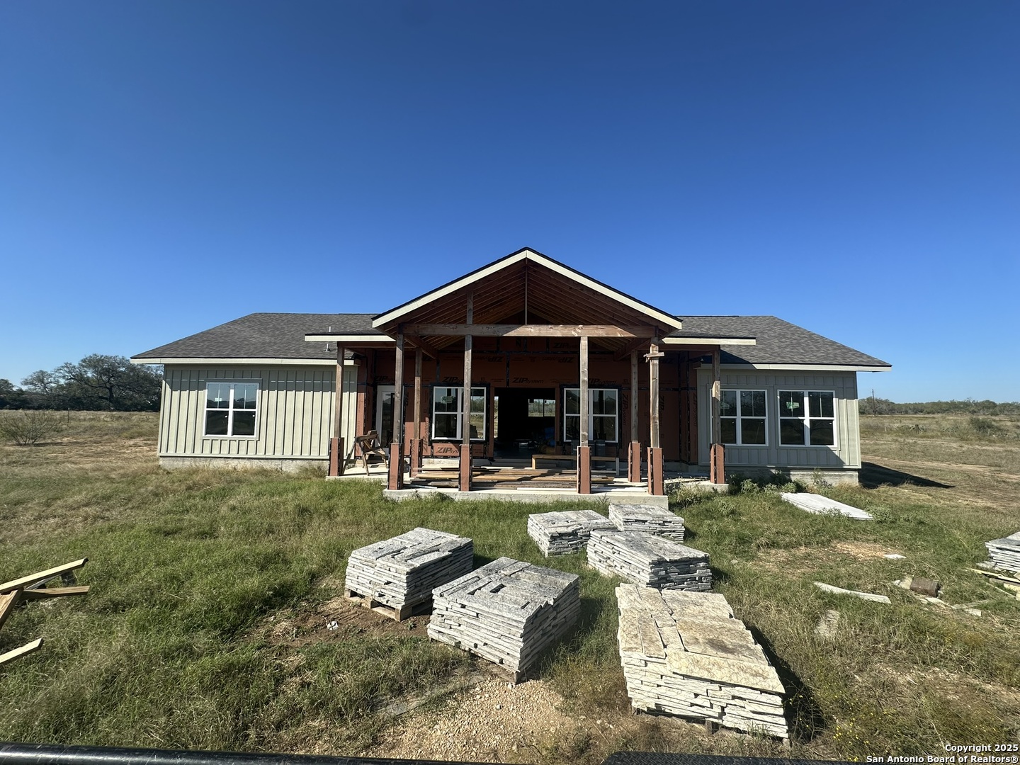 241 County Road 154 Pleasanton, TX 78064 - Photo 2 of 20 a front view of a house with a yard table and chairs