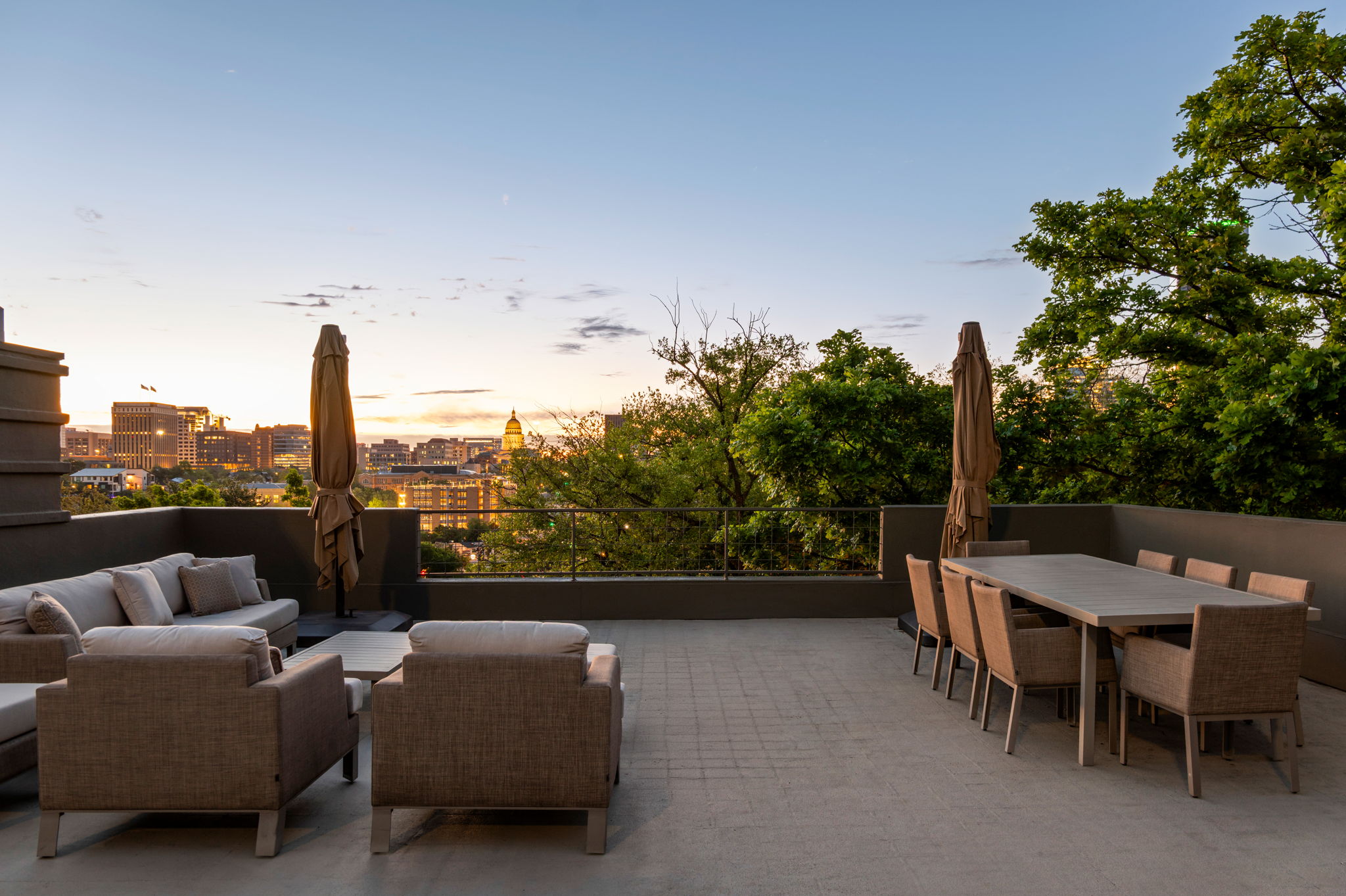 1111 West 12th Street, Unit 107 Austin, TX 78703 - Photo 13 of 38 Expansive rooftop terrace featuring a large dining area, lounge seating, paver flooring, and a metal railing