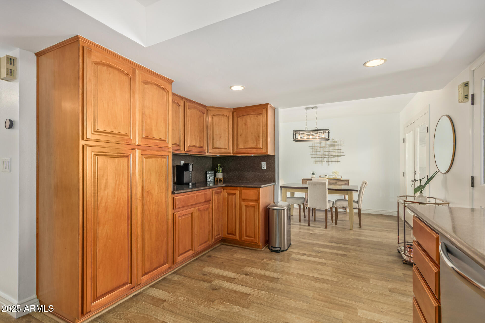 8490 East Chaparral Road Scottsdale, AZ 85250 - Photo 11 of 27 a kitchen with stainless steel appliances granite countertop a refrigerator and cabinets