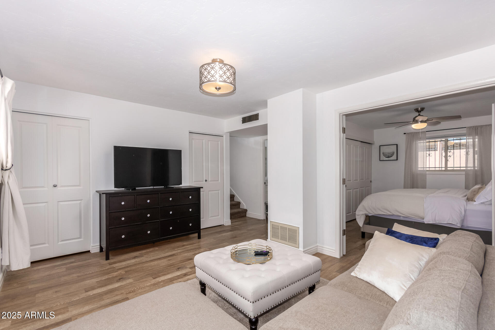 8490 East Chaparral Road Scottsdale, AZ 85250 - Photo 15 of 27 a living room with furniture and a flat screen tv