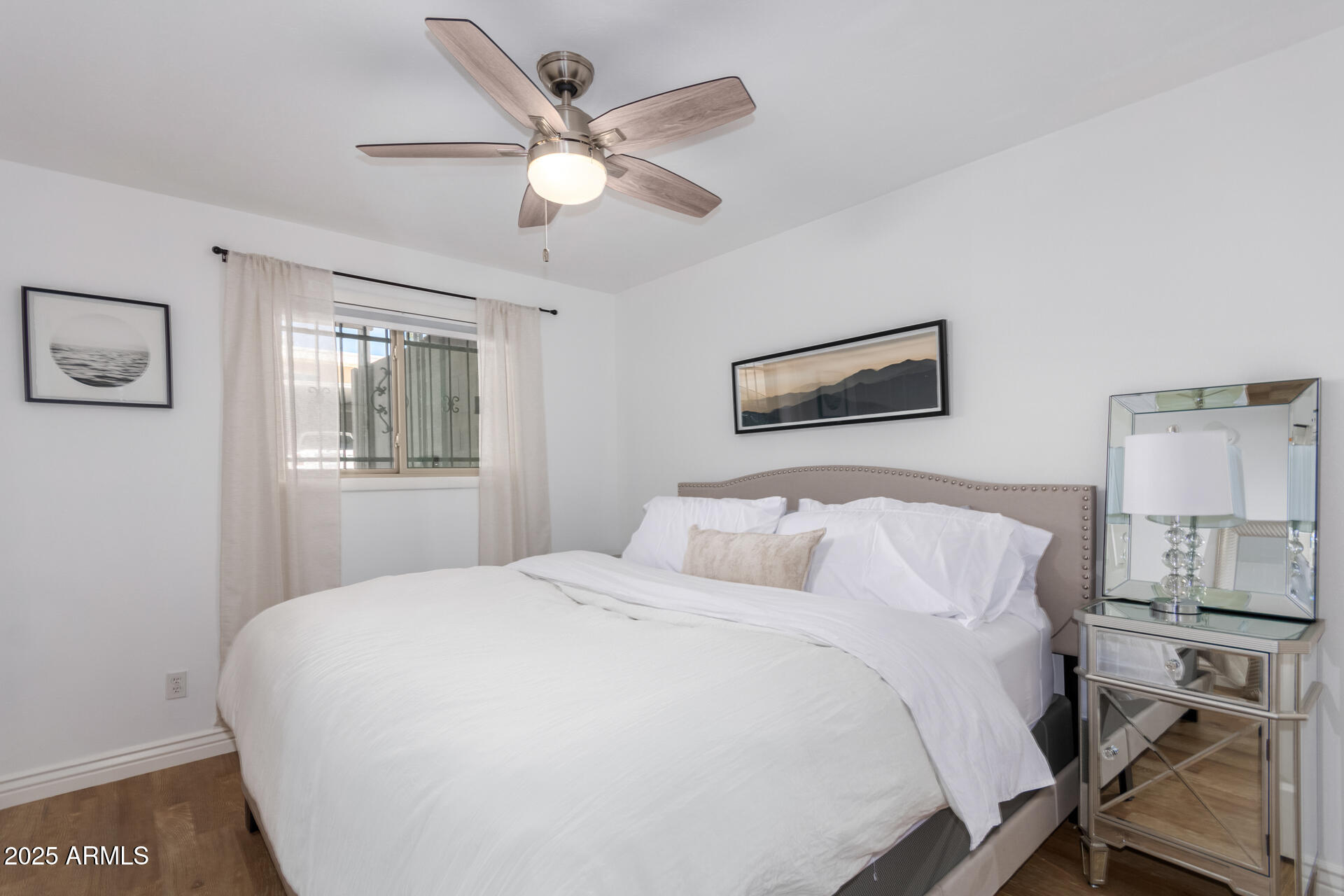 8490 East Chaparral Road Scottsdale, AZ 85250 - Photo 17 of 27 a bedroom with a large bed and a chandelier
