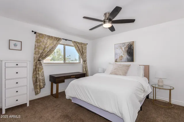 a bedroom with a bed and a window