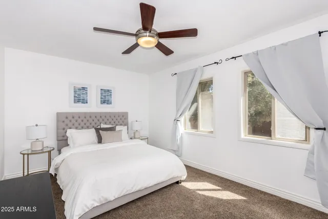 a bedroom with a large bed and a window