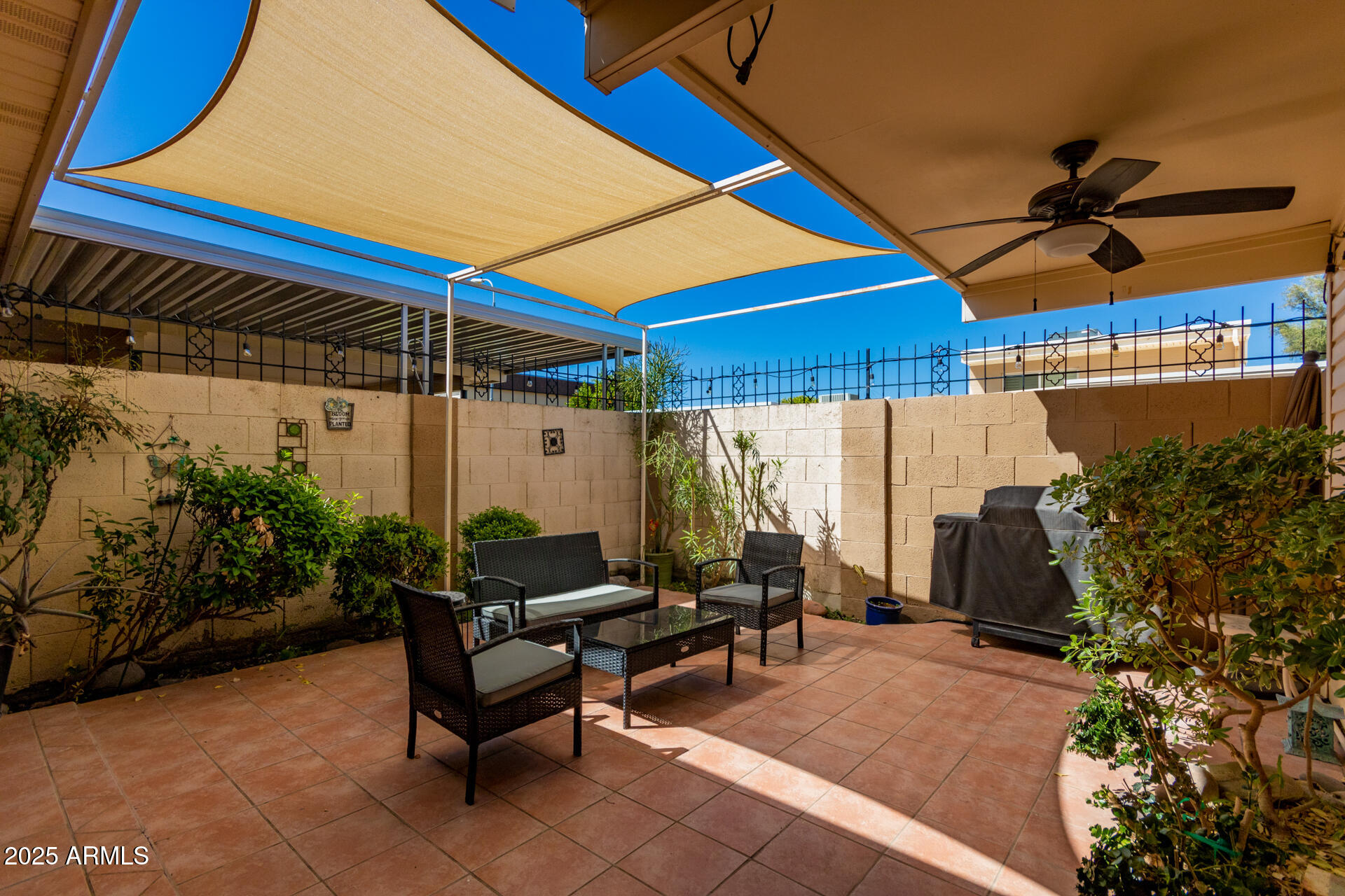 8490 East Chaparral Road Scottsdale, AZ 85250 - Photo 24 of 27 a living room with patio furniture and a potted plant
