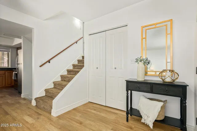 a view of entryway and hall with wooden floor