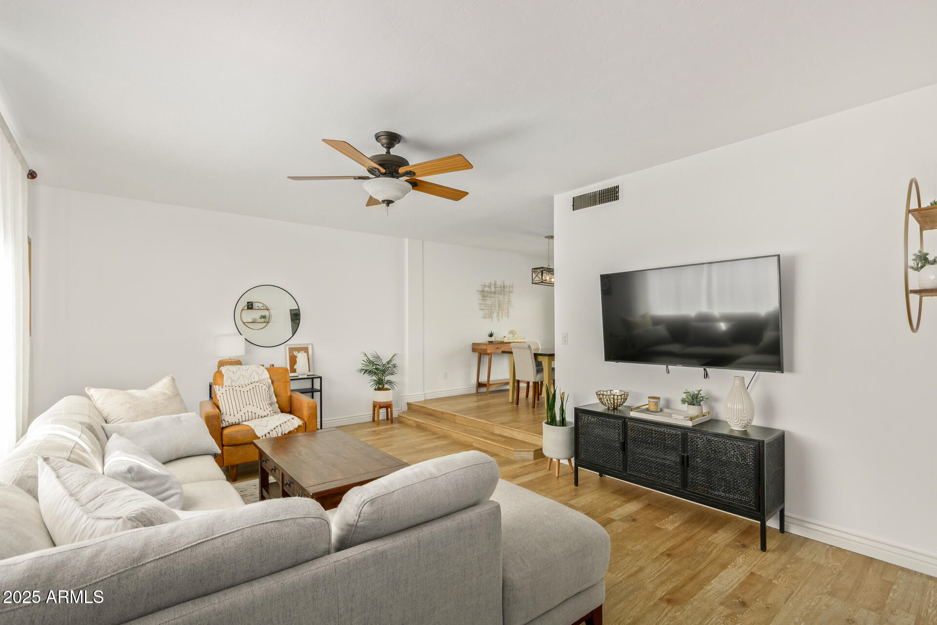 8490 East Chaparral Road Scottsdale, AZ 85250 - Photo 6 of 27 a living room with furniture and a flat screen tv