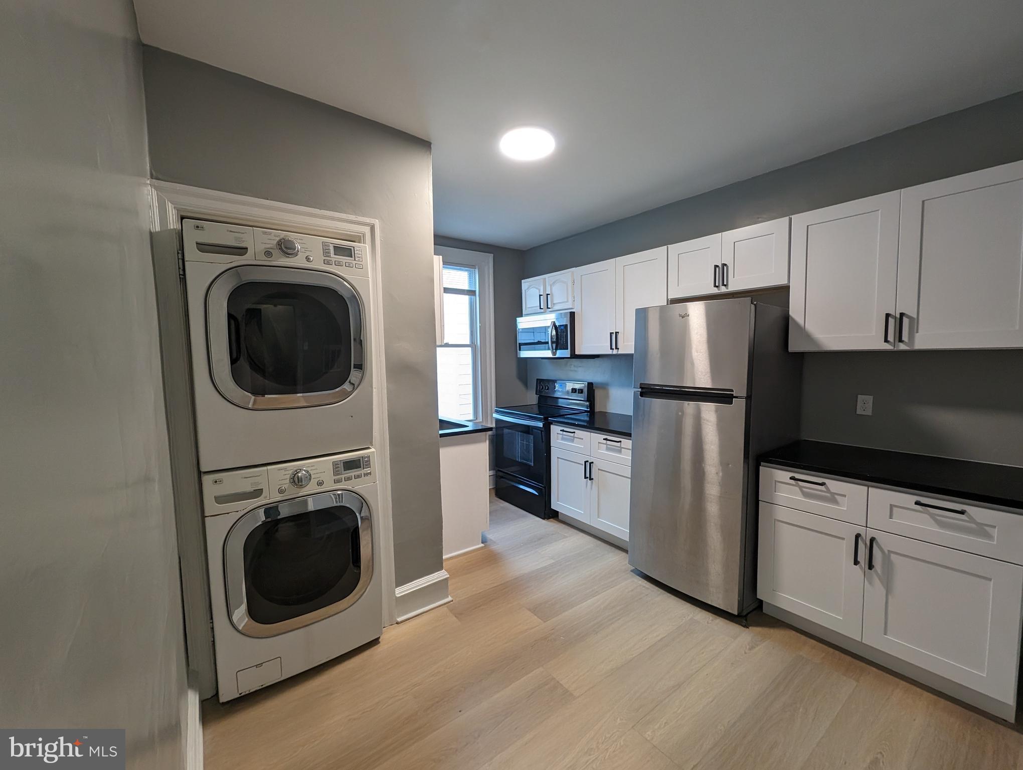 a kitchen with refrigerator a microwave and sink