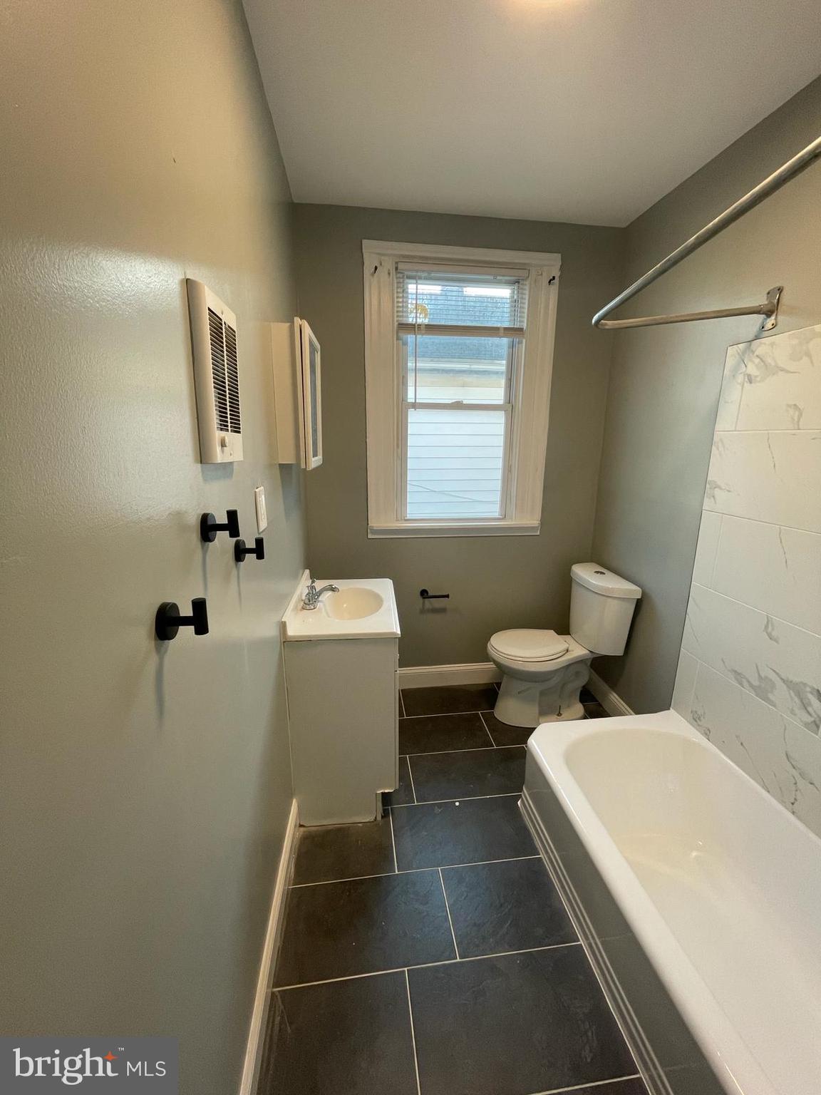 5750-52 Rising Sun Avenue, Unit 2A Philadelphia, PA 19120 - Photo 13 of 22 a bathroom with a toilet sink and mirror
