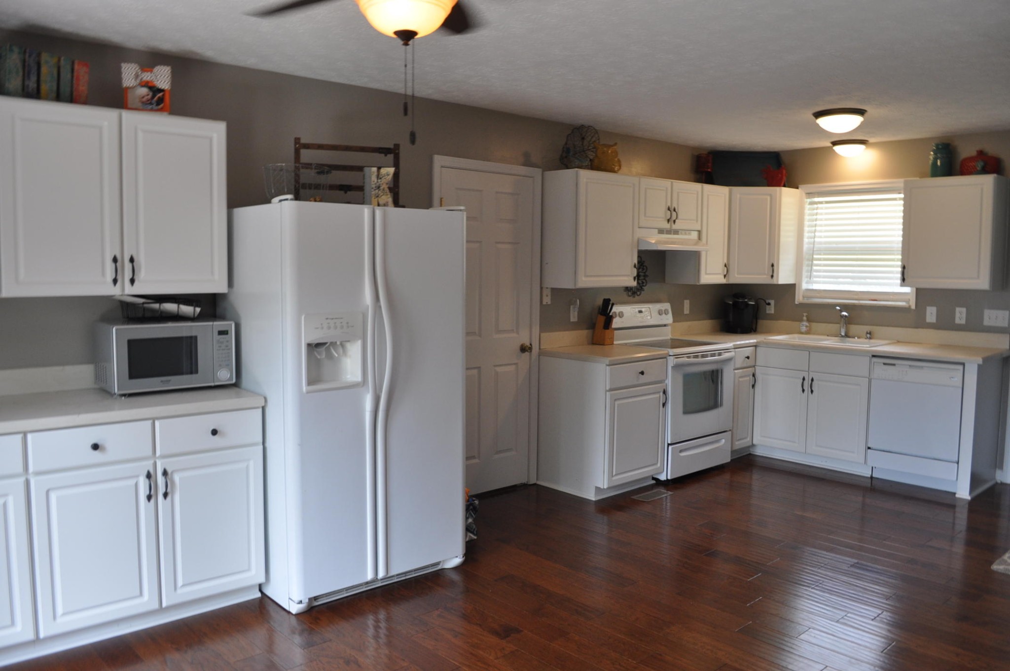 256 Rench Road Kingston, TN 37763 - Photo 5 of 23 a kitchen with cabinets stainless steel appliances a sink and wooden floor