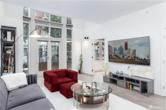 a living room with furniture and a painting