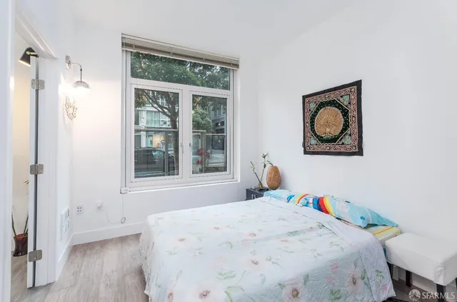 a bedroom with a bed and a window