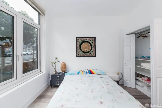 a view of a bedroom with a bed and a window