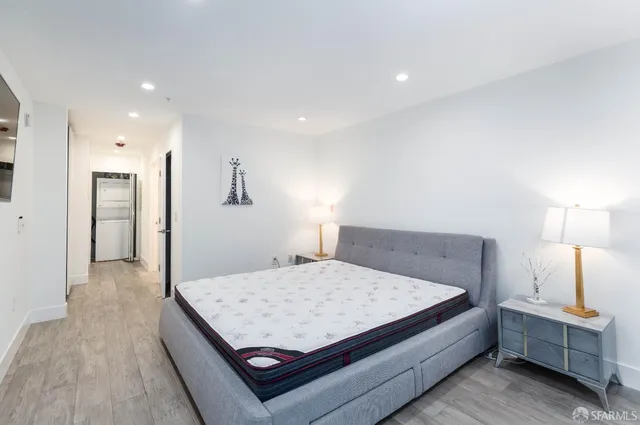 a bedroom with a bed and a lamp on table