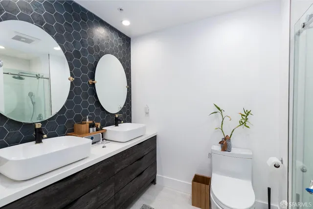 a bathroom with a double vanity sink and a mirror