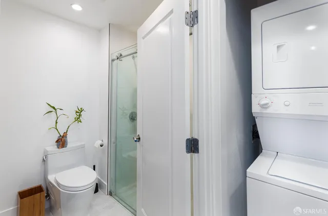 a bathroom with a toilet and a shower