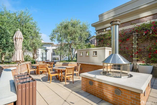 a view of a patio with couches table and chairs and potted plants