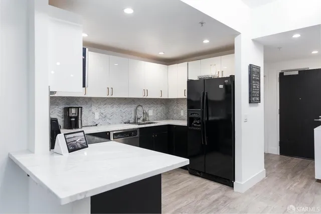 a kitchen with a refrigerator and a sink