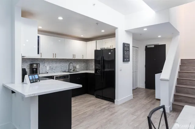 a kitchen with a sink stainless steel appliances and cabinets