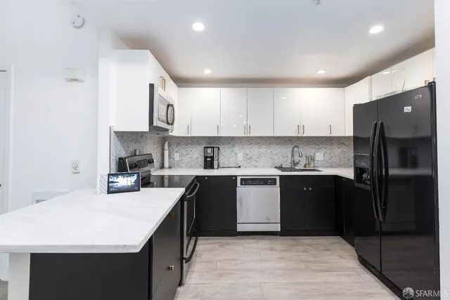a kitchen with a sink stove and refrigerator