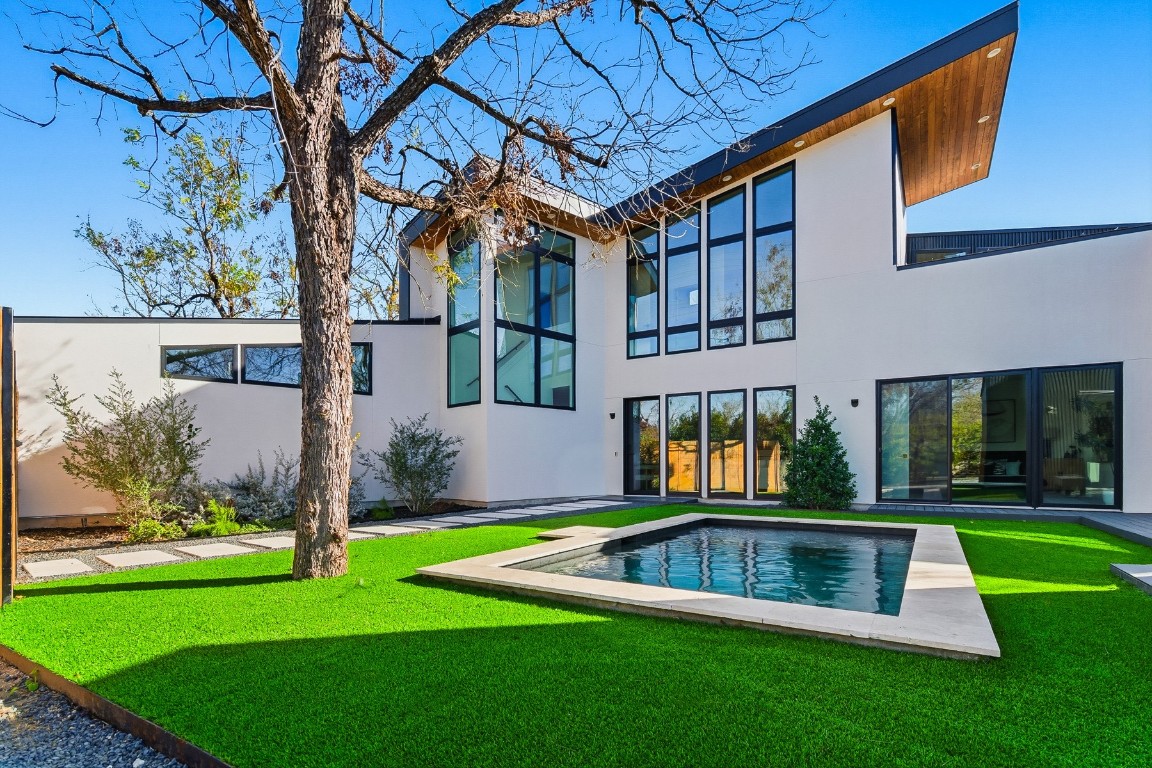 4613 Bolm Road Austin, TX 78702 - Photo 1 of 40 Back of house featuring stucco siding, a patio area, and a lawn